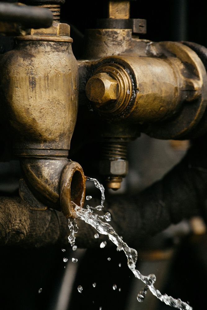 Water leaking from an old brass plumbing valve