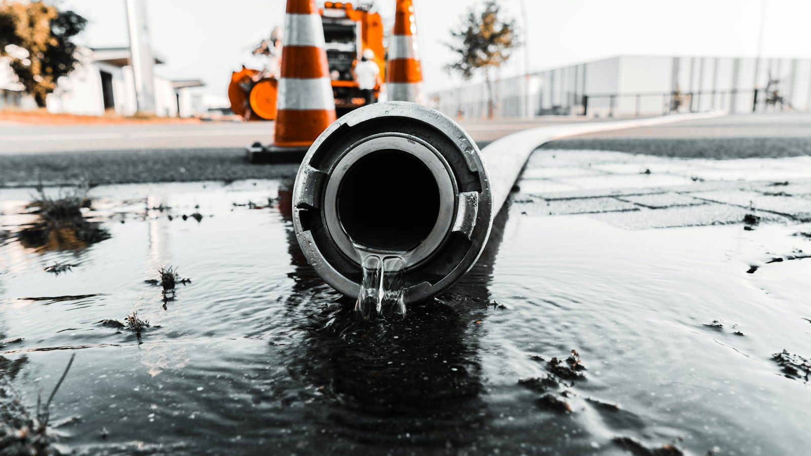 Water flowing from a large pipe at a work site